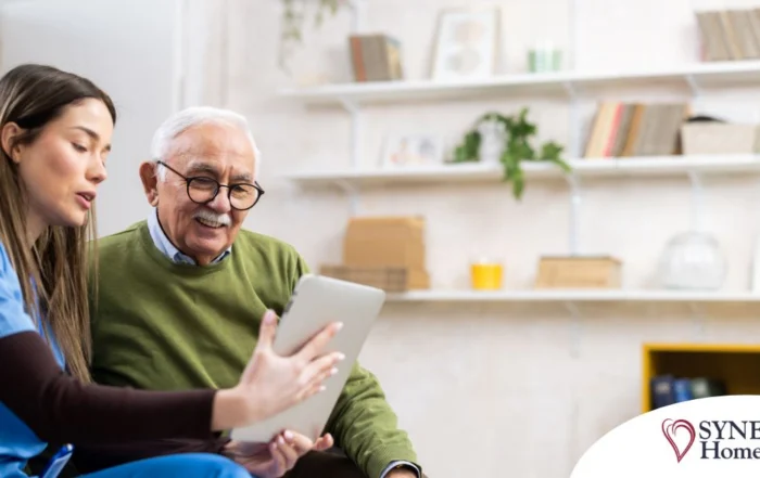 Home caregiver assisting senior man to use telehealth and senior care
